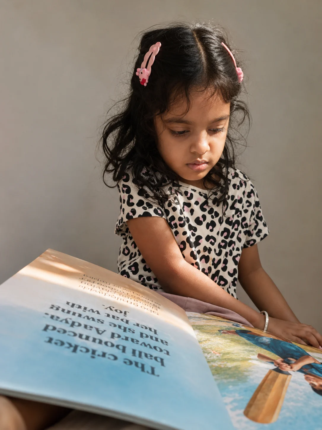 Aadya reading a personalised Little Bind storybook