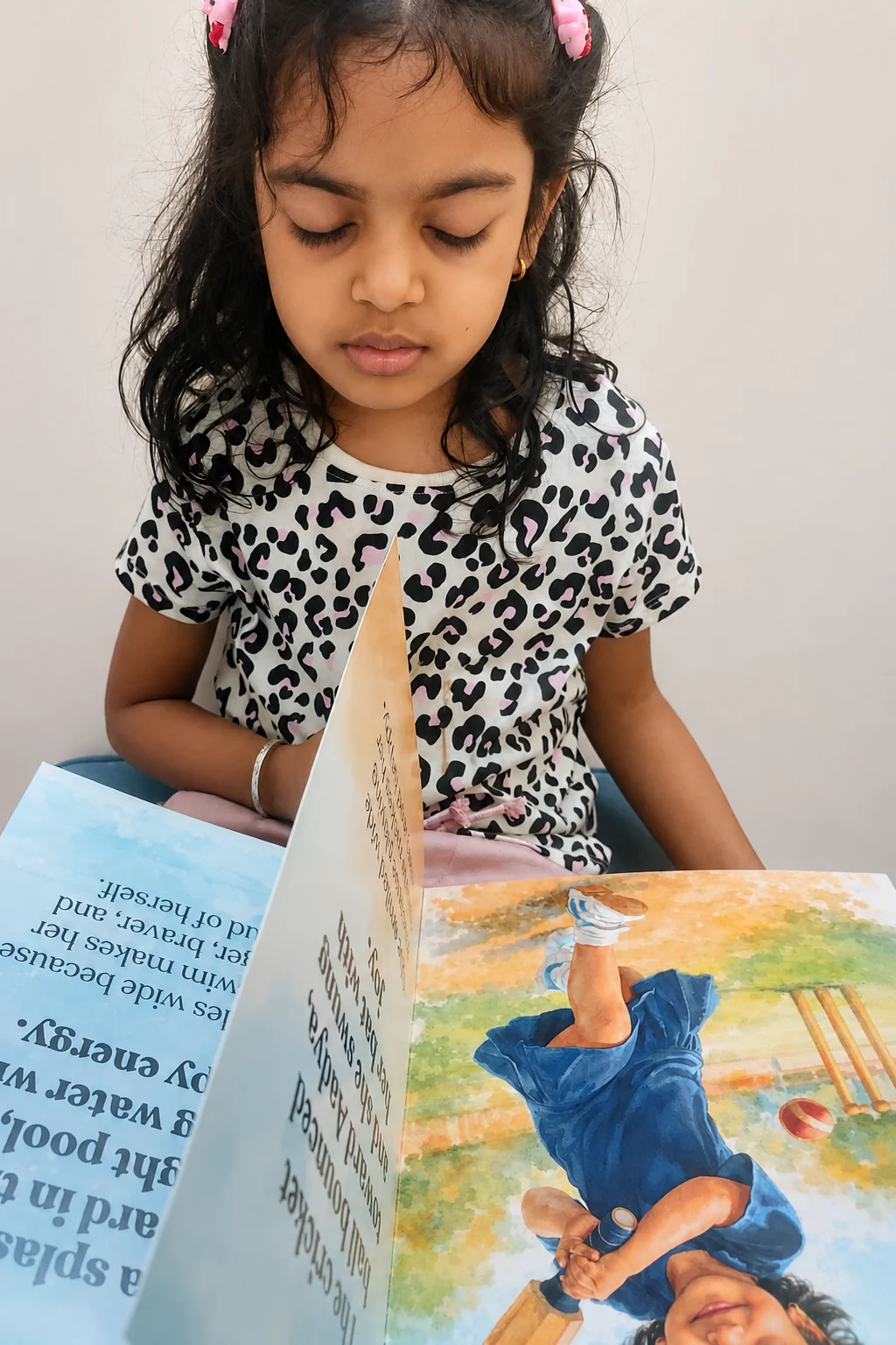 Aadya turning pages of a personalised Little Bind book
